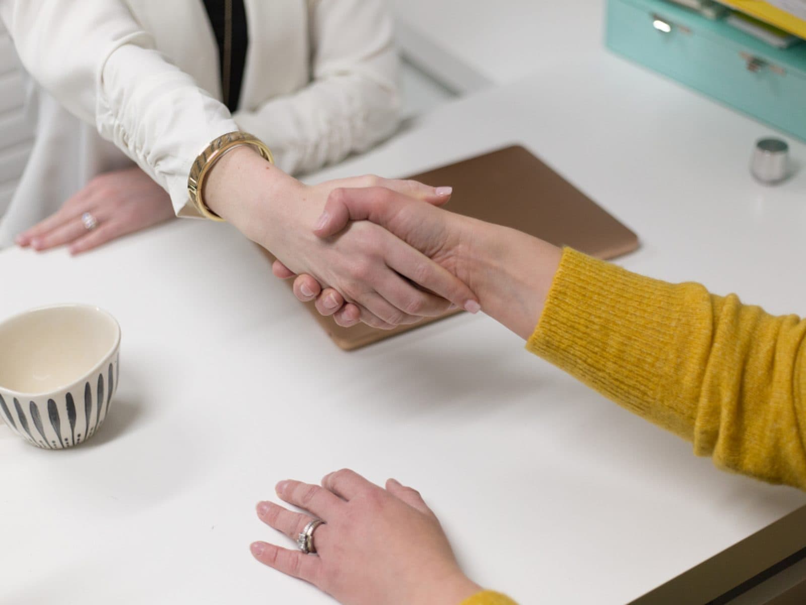 An adviser and a client talking across a desk